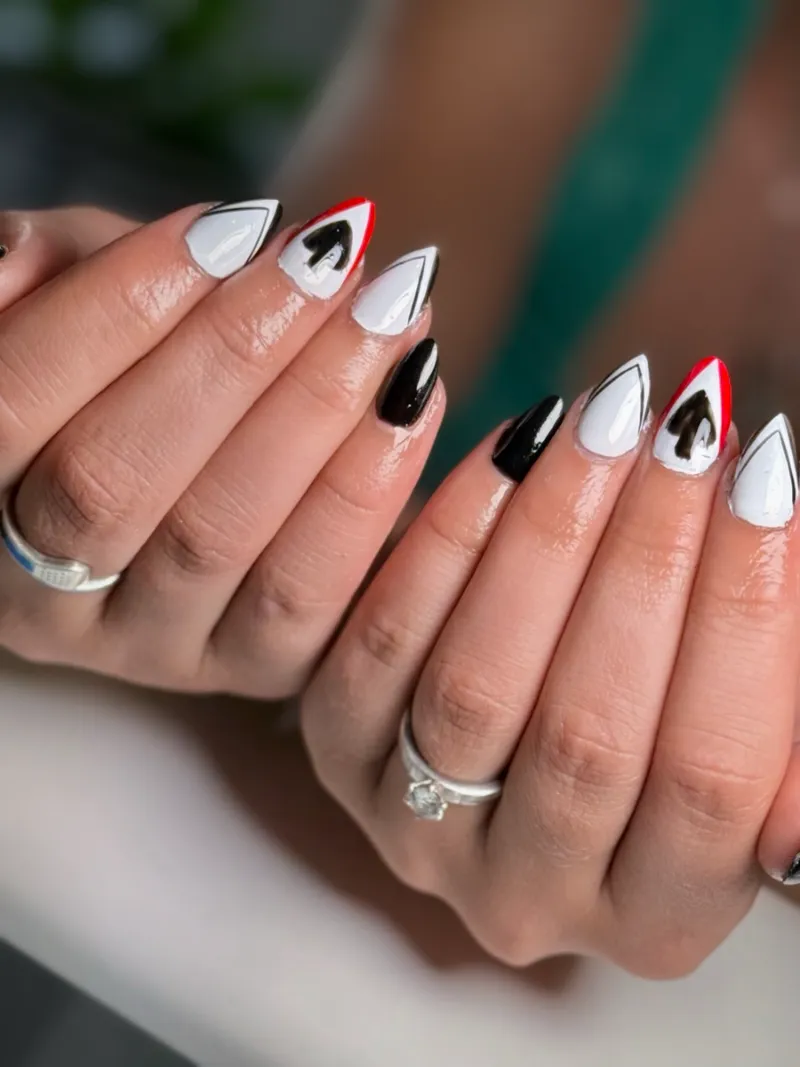 Black and white playing card suit nail art on stiletto nails