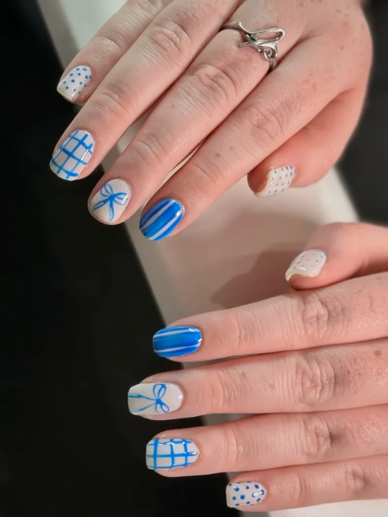 Blue gingham nail art with hand-painted bows by Nail Oasis